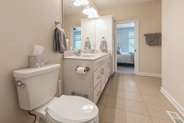 bathroom featuring baseboards, visible vents, toilet, and tile patterned floors