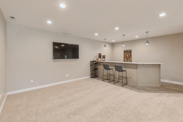 bar with a bar, visible vents, light colored carpet, and recessed lighting