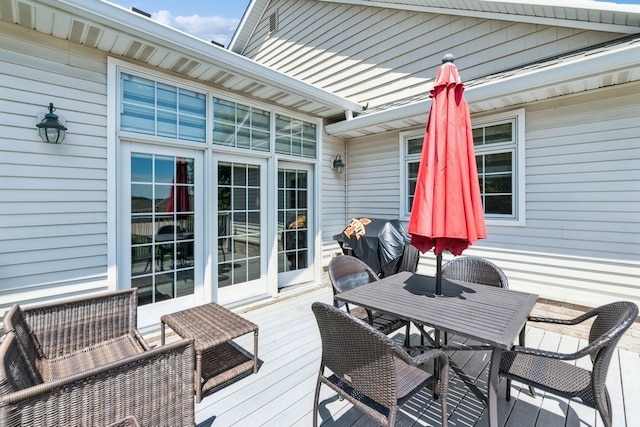 deck featuring area for grilling and outdoor dining space