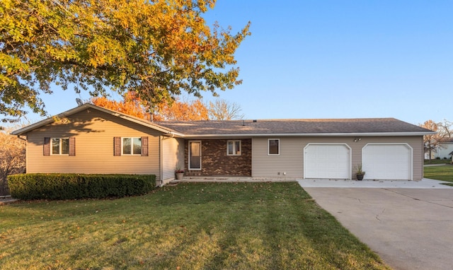 ranch-style home featuring a garage and a front yard