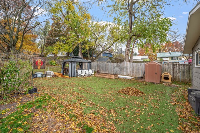 view of yard with a gazebo and a storage unit