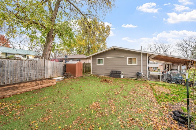 back of house featuring a yard and a storage shed