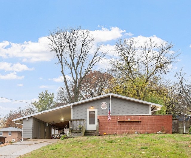 view of front facade with a front yard and a carport