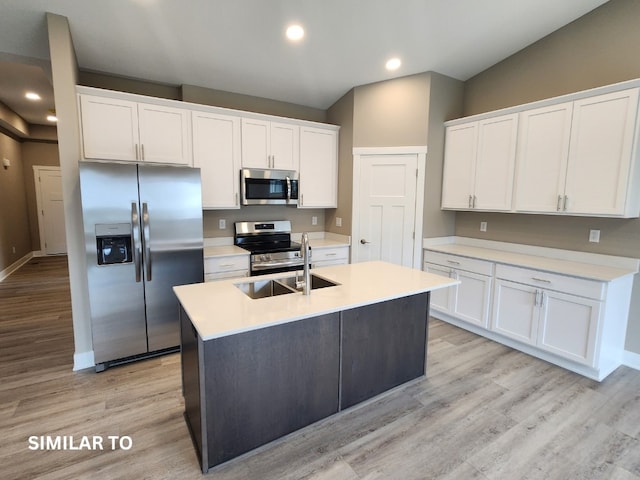 kitchen with light hardwood / wood-style floors, white cabinetry, sink, and appliances with stainless steel finishes