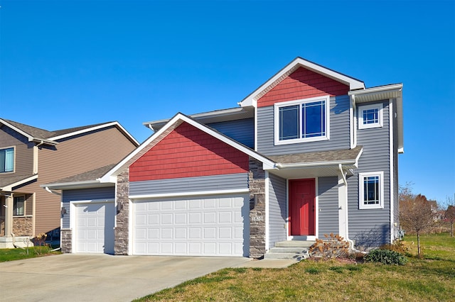 view of front of house with a front yard and a garage