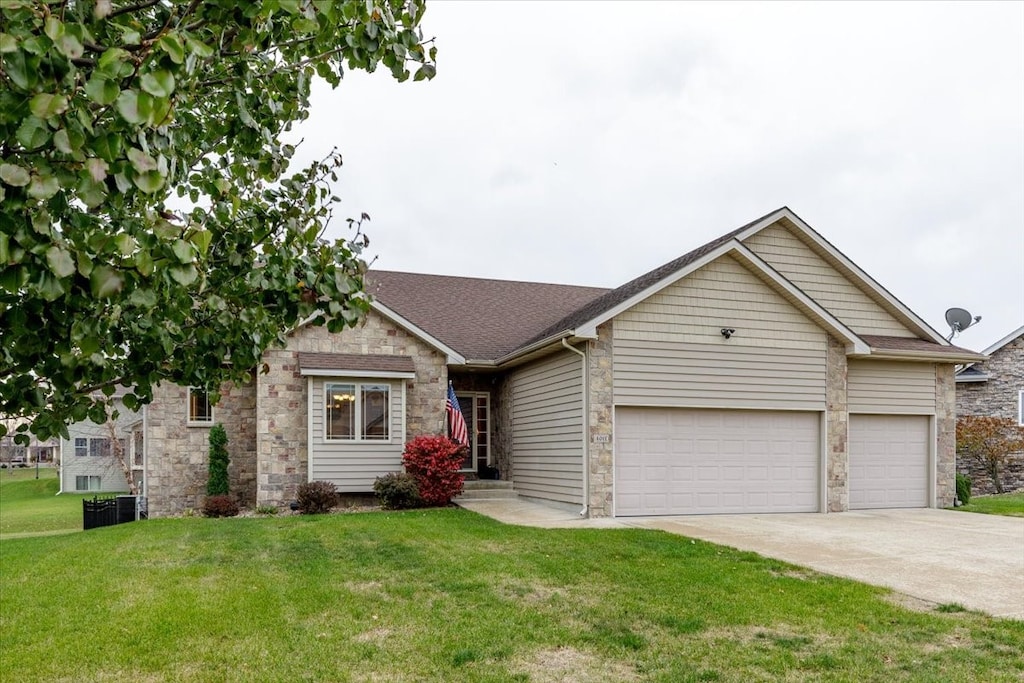 ranch-style home featuring a front yard and a garage