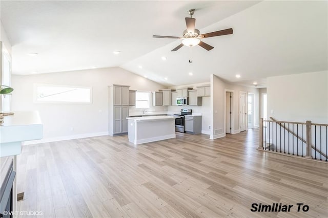 unfurnished living room with vaulted ceiling, ceiling fan, and light wood-type flooring