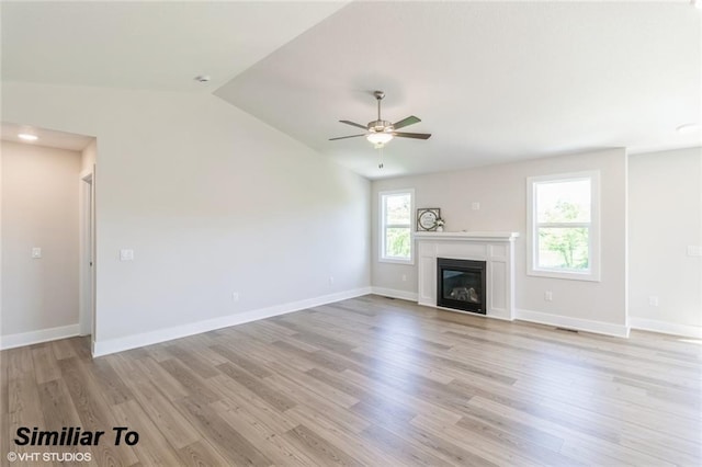 unfurnished living room featuring light wood-type flooring, vaulted ceiling, and ceiling fan