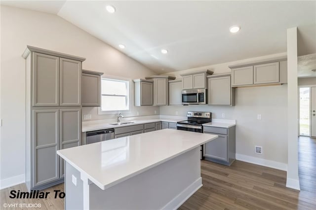 kitchen with gray cabinets and appliances with stainless steel finishes