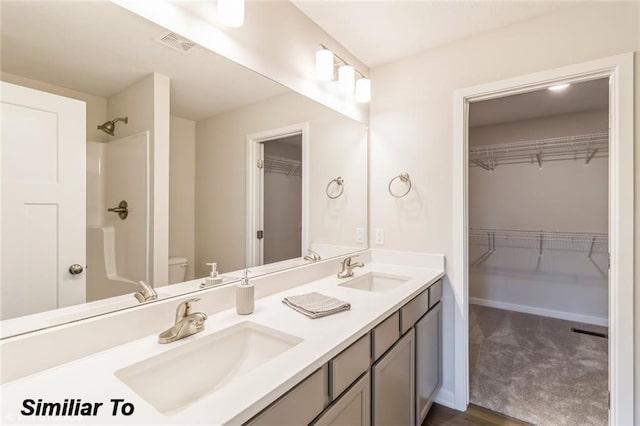 bathroom featuring vanity, toilet, hardwood / wood-style flooring, and a shower