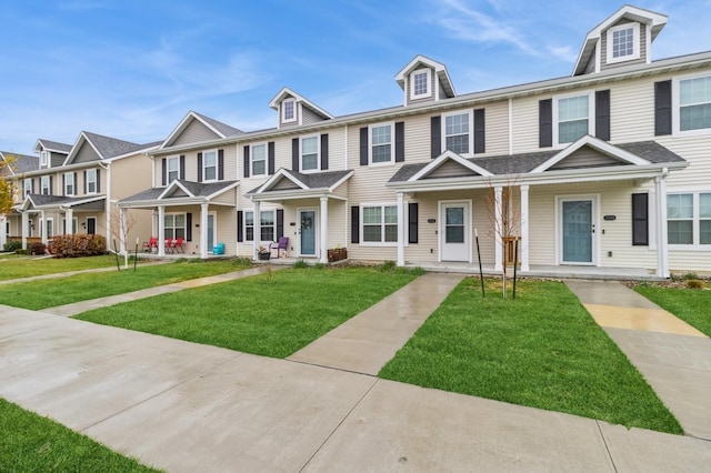 townhome / multi-family property with a front lawn and a porch