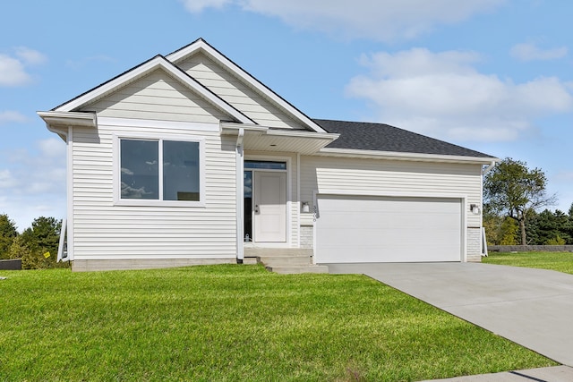 view of front of home with a front yard and a garage