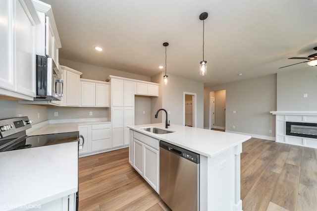 2806 22nd St SW, Altoona, IA 50009 - kitchen featuring stainless steel appliances, a sink, open floor plan, a ceiling fan, and recessed lighting