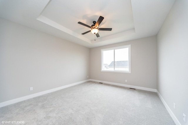 2806 22nd St SW, Altoona, IA 50009 - unfurnished room with a tray ceiling, ceiling fan, light carpet, and baseboards