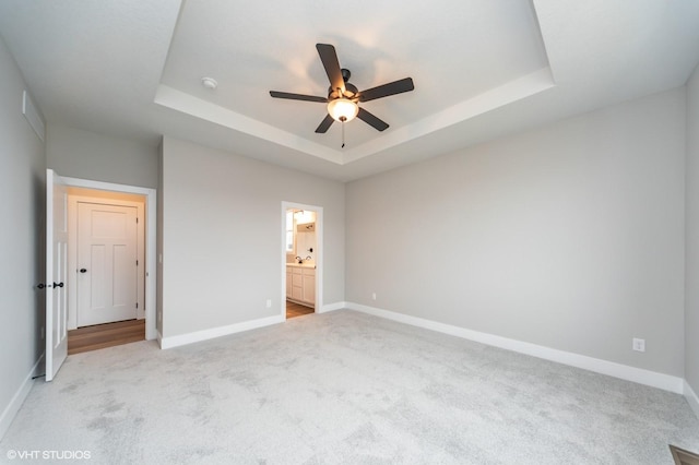 2806 22nd St SW, Altoona, IA 50009 - unfurnished bedroom with carpet floors, a tray ceiling, and baseboards