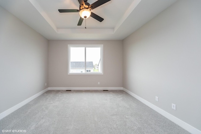 2806 22nd St SW, Altoona, IA 50009 - carpeted empty room with a tray ceiling, baseboards, and a ceiling fan