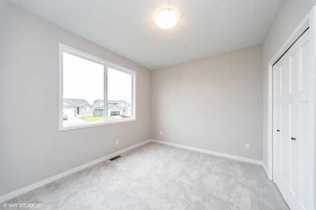 2806 22nd St SW, Altoona, IA 50009 - unfurnished bedroom featuring carpet flooring, a closet, and baseboards