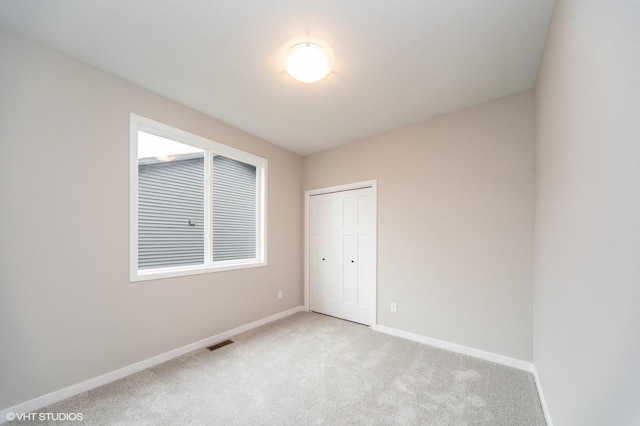 2806 22nd St SW, Altoona, IA 50009 - unfurnished bedroom featuring light colored carpet, baseboards, and a closet