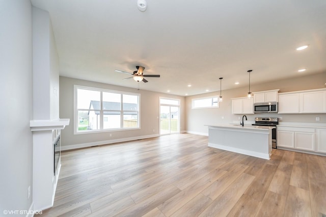 2806 22nd St SW, Altoona, IA 50009 - kitchen with stainless steel appliances, light wood-style flooring, recessed lighting, a ceiling fan, and open floor plan