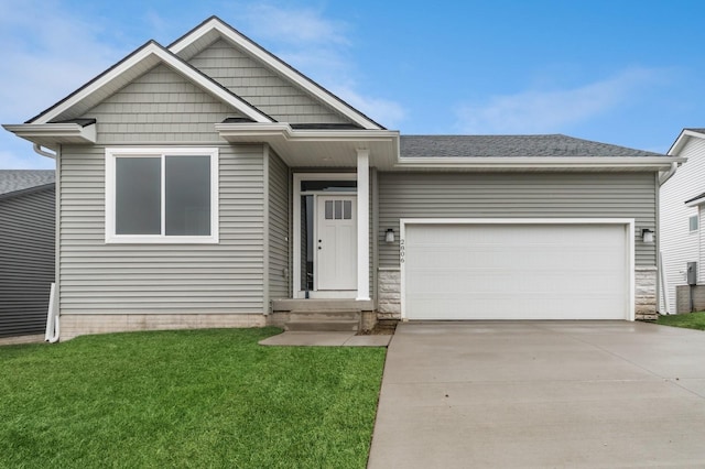 2806 22nd St SW, Altoona, IA 50009 - view of front facade featuring driveway, an attached garage, a front yard, a shingled roof, and stone siding
