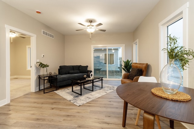 living room with ceiling fan and light wood-type flooring