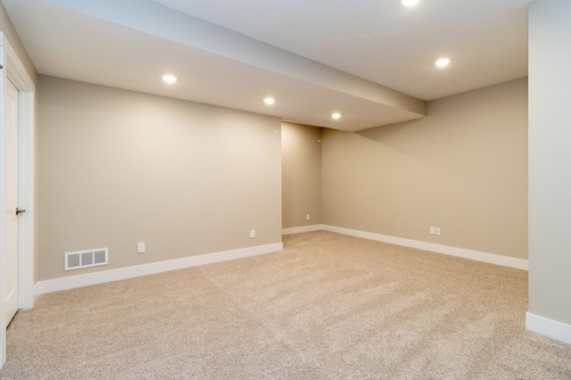 basement featuring light carpet