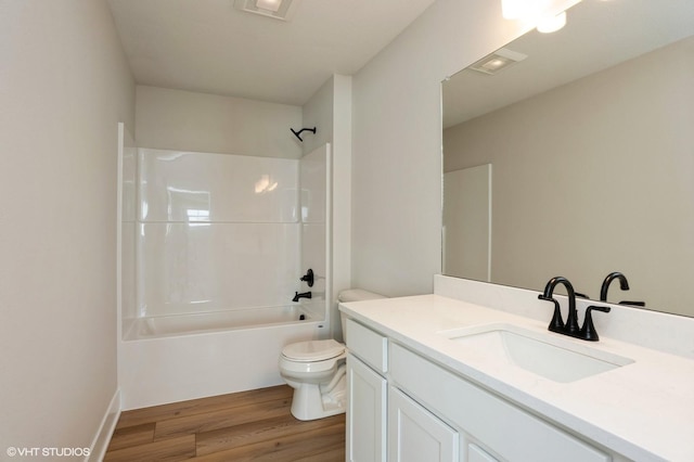 full bathroom featuring shower / bath combination, vanity, toilet, and wood finished floors