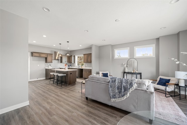 living room with a textured ceiling, plenty of natural light, and dark hardwood / wood-style floors