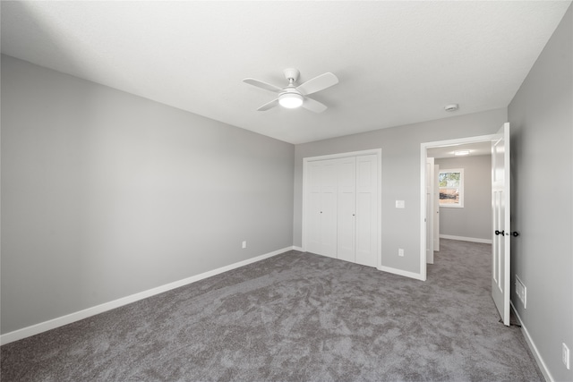 unfurnished bedroom featuring carpet floors, a closet, and ceiling fan