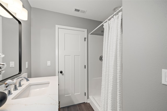 bathroom featuring vanity, a shower with curtain, and hardwood / wood-style flooring