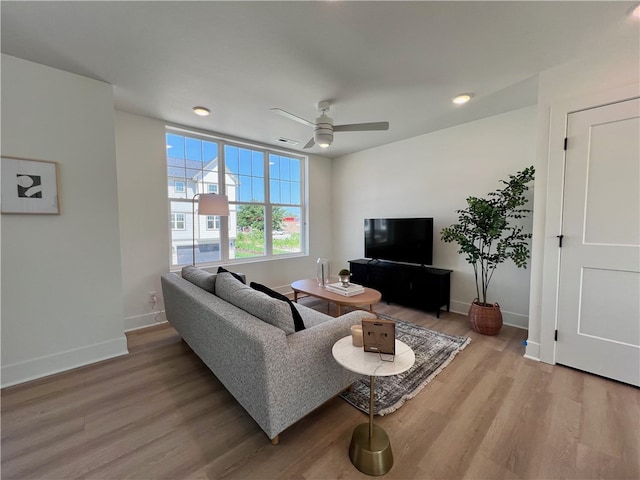 living room with hardwood / wood-style floors and ceiling fan