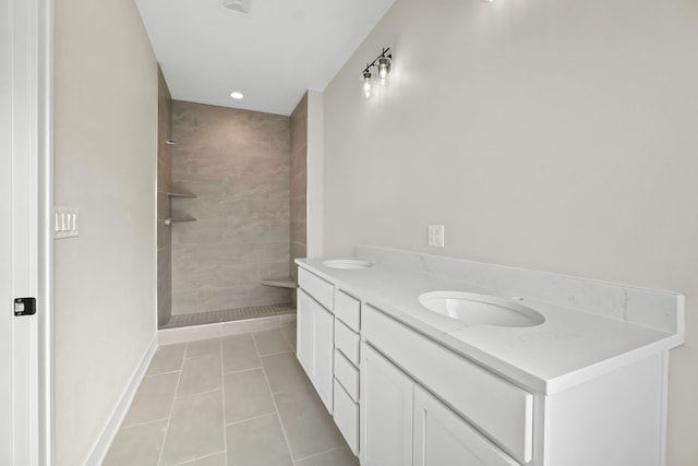 bathroom featuring vanity, tiled shower, and tile patterned floors