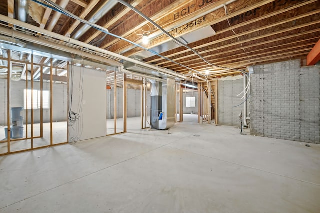 basement with brick wall and heating unit