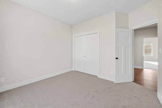 unfurnished bedroom with carpet floors and a closet