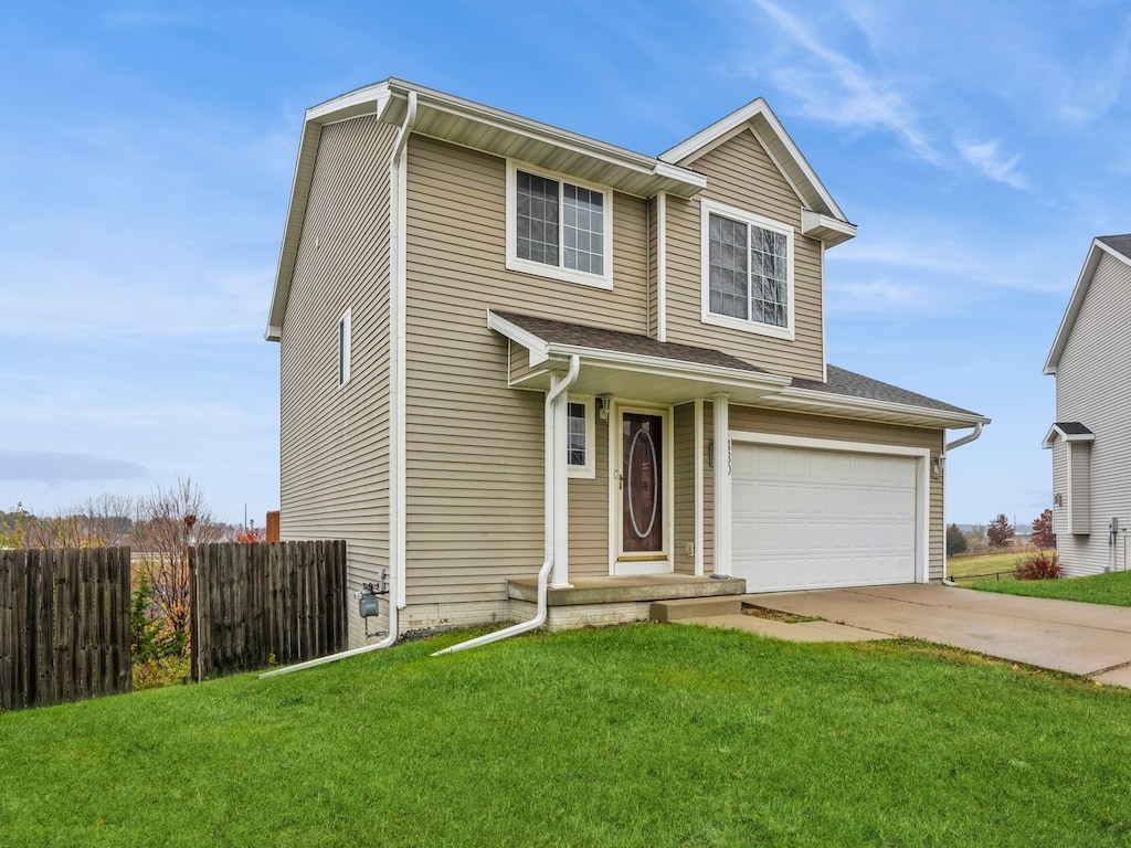 view of front of house with a front lawn and a garage