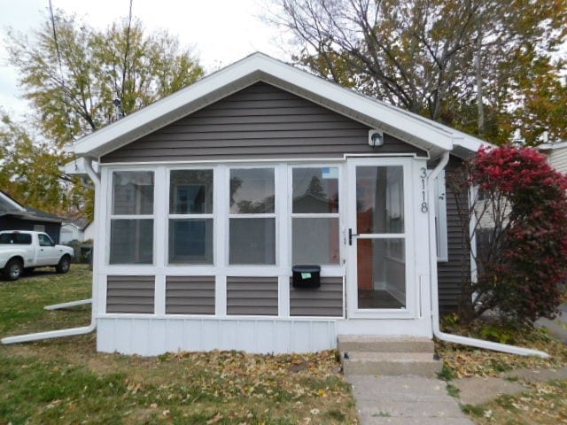 view of front of home with a sunroom