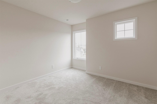 carpeted empty room featuring plenty of natural light