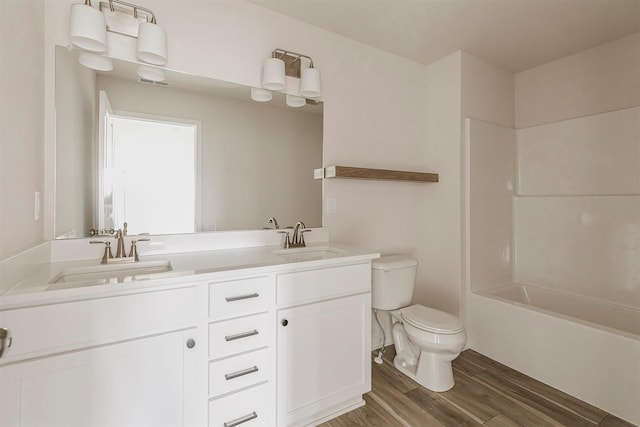 full bathroom with vanity, bathtub / shower combination, hardwood / wood-style floors, and toilet