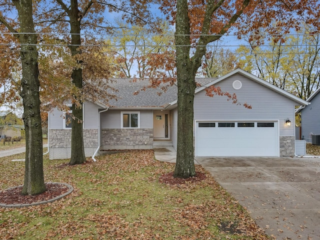 single story home with a garage, stone siding, central AC unit, and concrete driveway