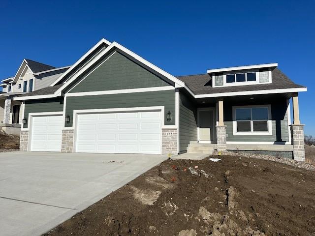 craftsman-style home featuring covered porch and a garage