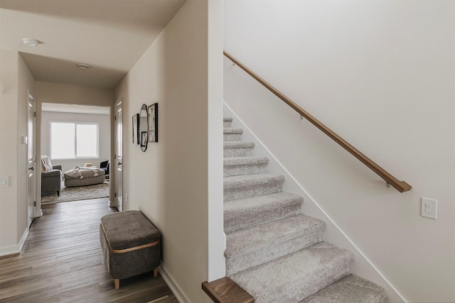 stairs with hardwood / wood-style flooring