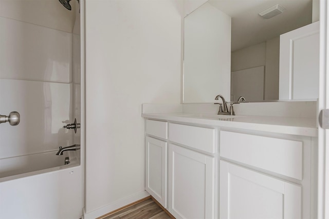 bathroom featuring vanity, hardwood / wood-style floors, and shower / bathing tub combination