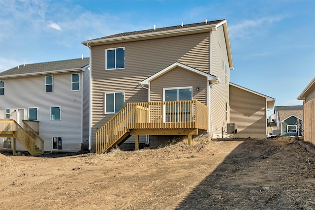 rear view of property featuring a wooden deck