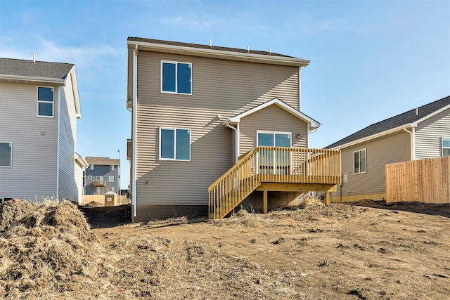 rear view of house featuring a wooden deck