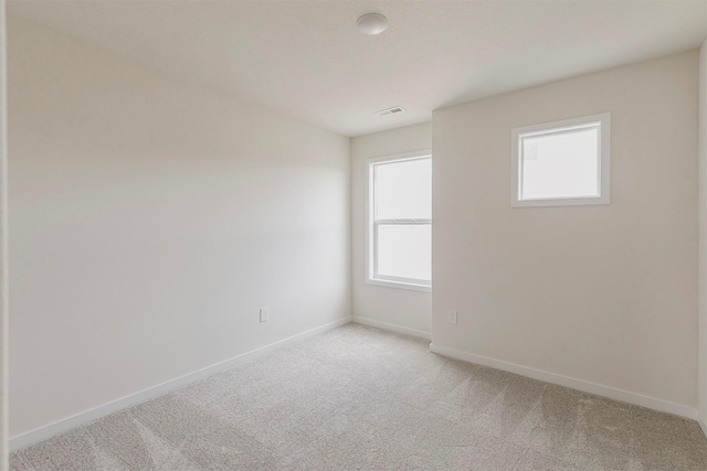 unfurnished room with light carpet