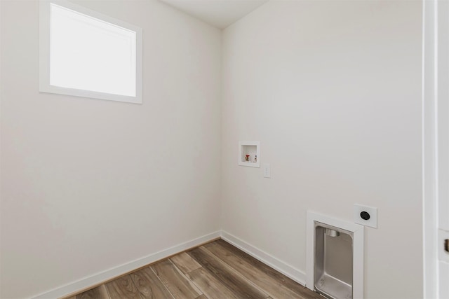 washroom with hardwood / wood-style flooring, hookup for an electric dryer, and hookup for a washing machine