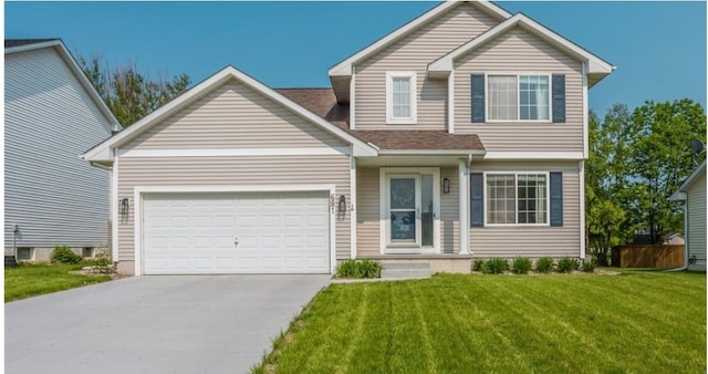 view of front of property with a front yard and a garage