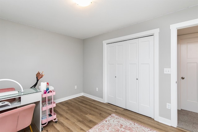 home office with light hardwood / wood-style flooring