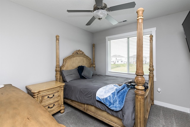 bedroom featuring ceiling fan and dark carpet