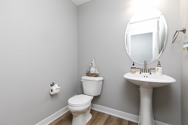 bathroom with wood-type flooring and toilet